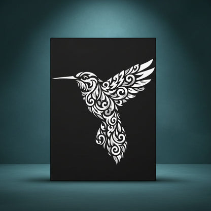 Black and white rhinestone canvas art of a hummingbird in flight, filled with intricate tribal and floral scrollwork detailing, mounted on a gallery-wrapped matte canvas with a deep black background.