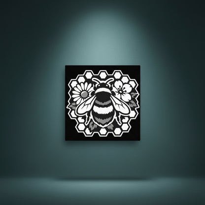 Black and white rhinestone canvas art of a detailed bumble bee centered on a bold honeycomb frame, surrounded by delicate flowers and foliage, mounted on a gallery-wrapped matte canvas with a deep black background."